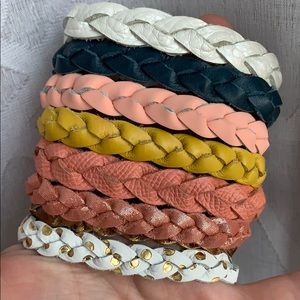 Braided leather bracelets, snap closures.